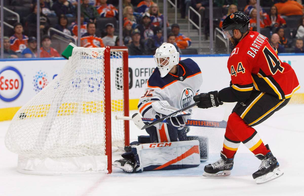 Calgary Flames defenceman Matt Bartkowski (44) scores on Edmonton Oilers goalie Edward Pasquale (32) during third period NHL preseason action in Edmonton, Alta., on Monday September 18, 2017.
