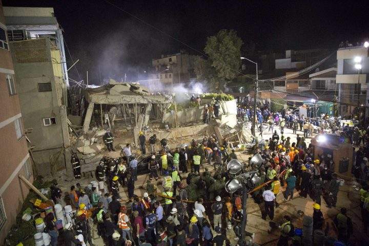Volunteers and rescue workers search for children trapped inside at the collapsed Enrique Rebsamen school in Mexico City, on Sept. 19, 2017.