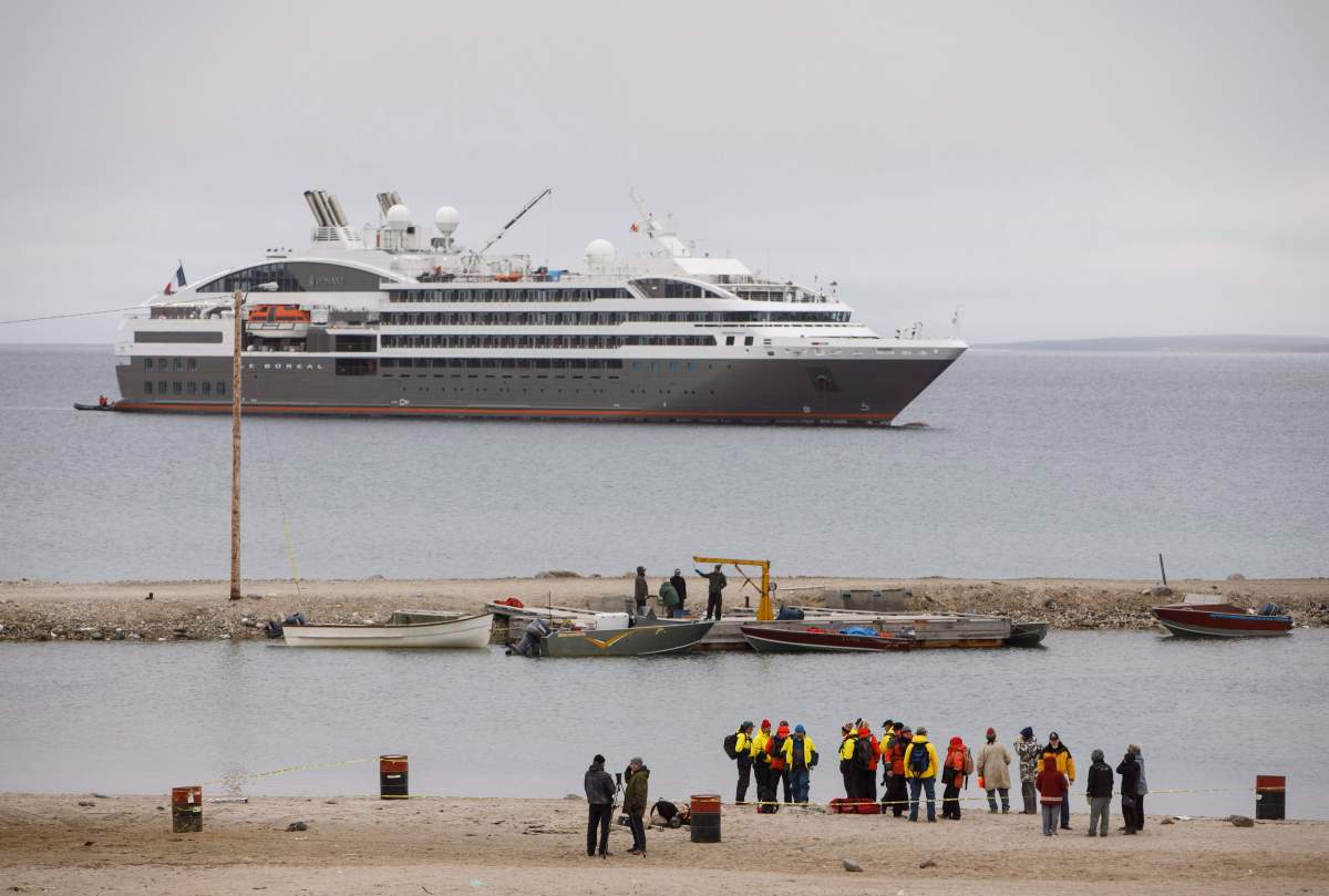 Passengers from a cruise ship reach the shore on zodiac boats during a visit to the town of Gjoa Haven, Nunavut on Saturday September 3, 2017.
