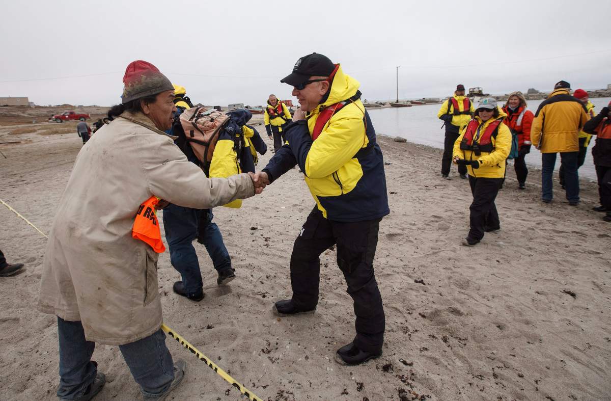 Tourists are greeted by a local after leaving a cruise ship in the bay of Gjoa Haven, Nunavut on Saturday September 3, 2017.