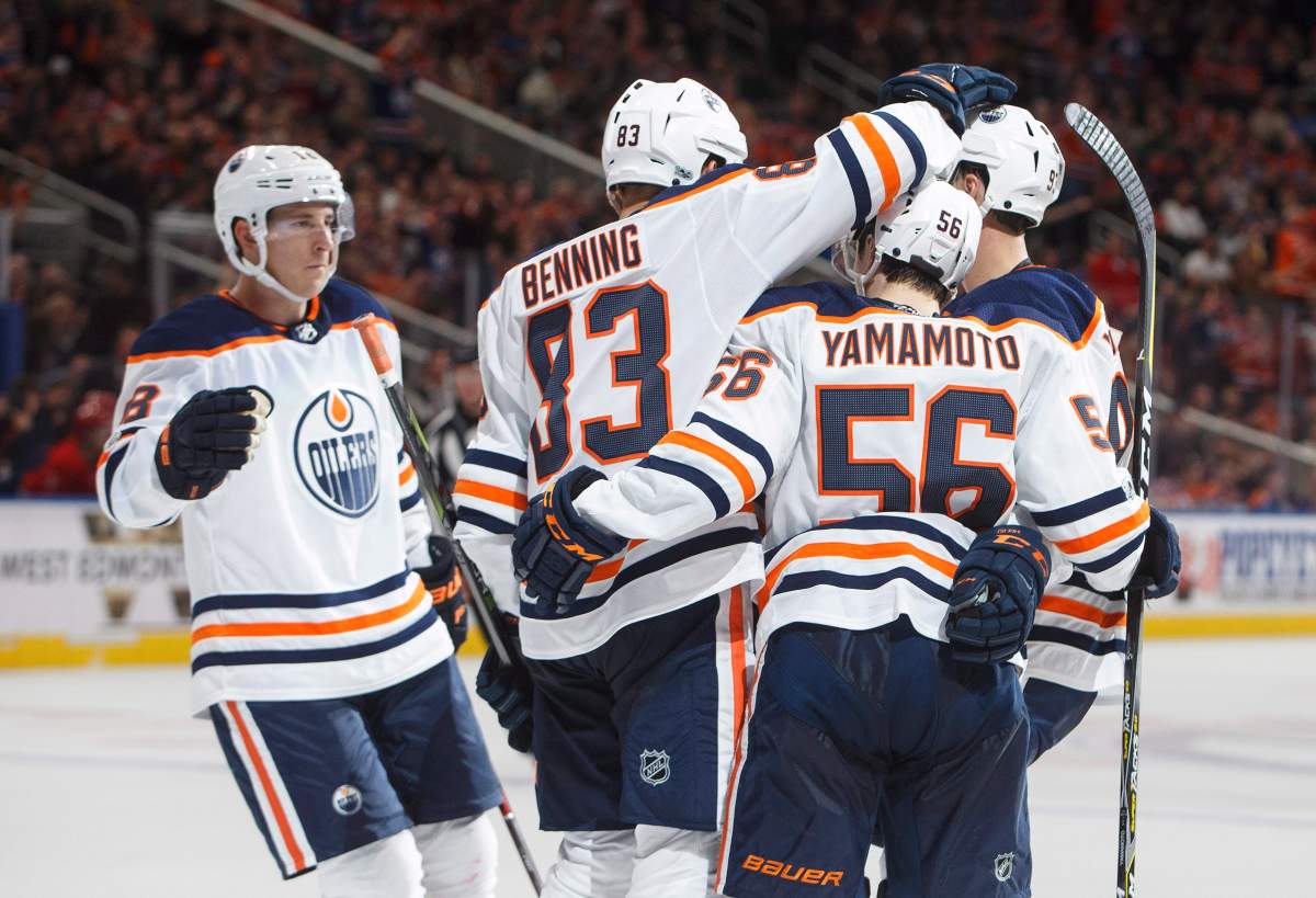Edmonton Oilers' Ryan Strome (18), Matthew Benning (83), Kailer Yamamoto (56) and Ryan Nugent-Hopkins (93) celebrate a goal against the Carolina Hurricanes during second period preseason NHL action in Edmonton, Alta., on Monday September 25, 2017. THE CANADIAN PRESS/Jason Franson.