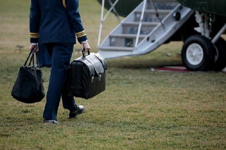 A military aide carries the alleged ‘football,’ a case with the launch codes for nuclear weapons, toward Marine One as U.S. President Donald Trump prepares to take off on the South Lawn of the White House on Jan. 26.