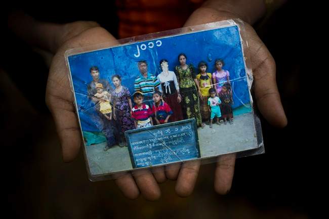Rohingya Mubarak Begum, who crossed over from Myanmar into Bangladesh, holds a photograph of her family members, in Kutupalong, Bangladesh, Friday, Sept. 8, 2017.