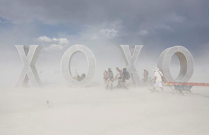 Participants make their way past an art installation as approximately 70,000 people from all over the world gathered for the annual Burning Man arts and music festival in the Black Rock Desert of Nevada, August 30, 2017.