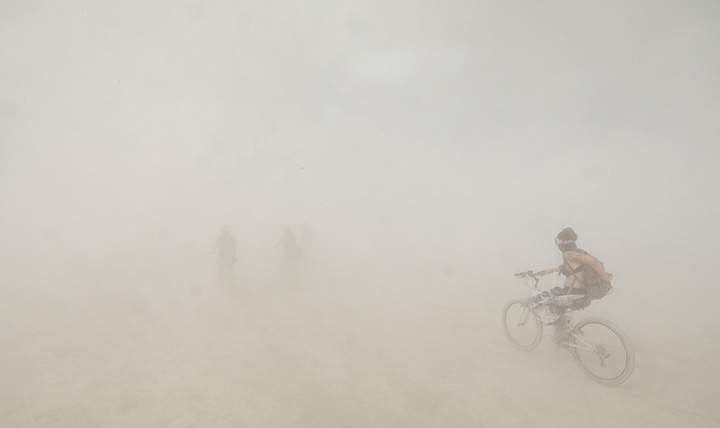 Burning Man participants bicycle through a desert dust storm as approximately 70,000 people from all over the world attend the 3rd day of the annual Burning Man arts and music festival in the Black Rock Desert of Nevada, August 30, 2017.