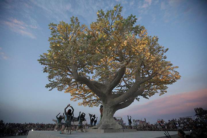 Burning Man participants perform in front of a huge art project called the “Tree of Tenere during the 3rd day of the 2017 Burning Man festival in the Black Rock Desert of Nevada, August 30, 2017.