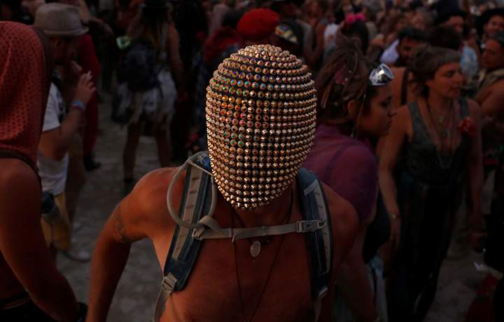 A participant wears a mask as he dances as approximately 70,000 people from all over the world gathered for the annual Burning Man arts and music festival in the Black Rock Desert of Nevada, U.S. August 29, 2017.