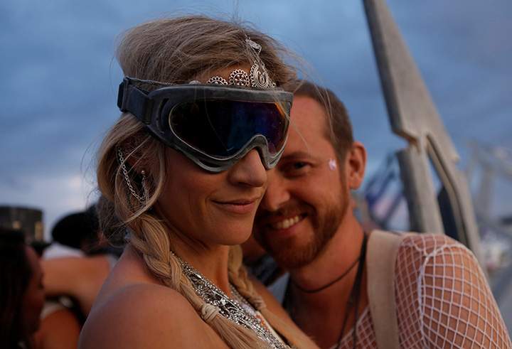 Pippa Sutherland (L) and AJ Bertenshaw dance during the Burning Man arts and music festival in the Black Rock Desert of Nevada, August 29, 2017.