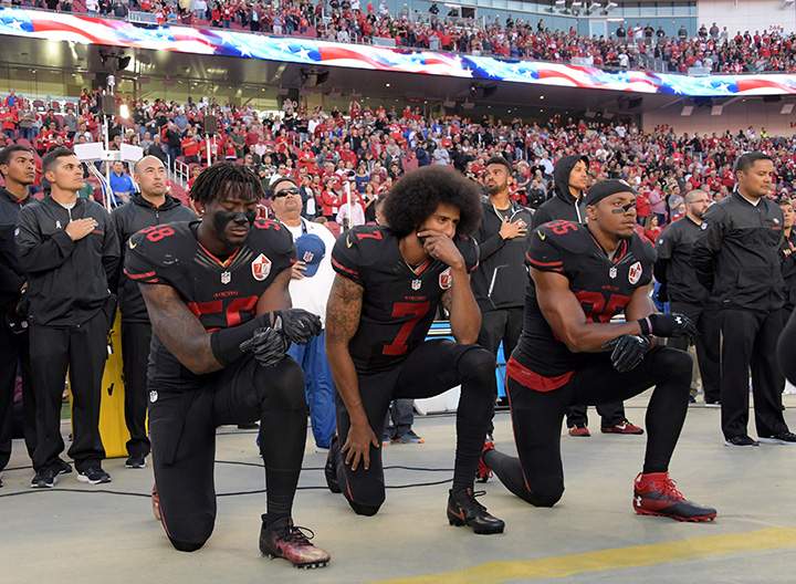 San Francisco 49ers outside linebacker Eli Harold (58), quarterback Colin Kaepernick (7) and free safety Eric Reid (35) kneel in protest during the playing of the national anthem before a NFL game against the Arizona Cardinals in Santa Clara, California, Oct 6, 2016.