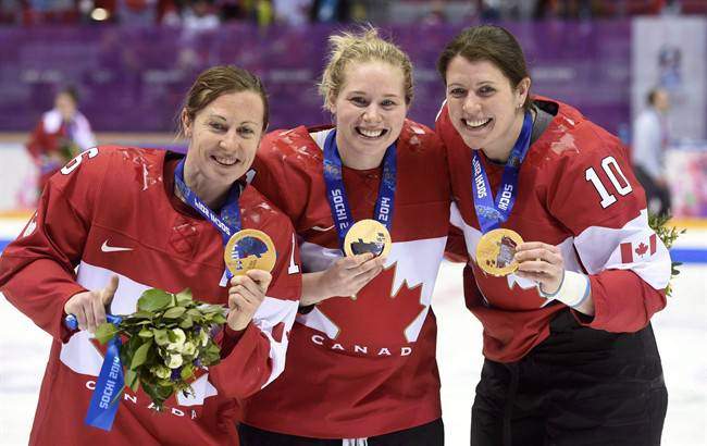 Canadians pose with gold medal