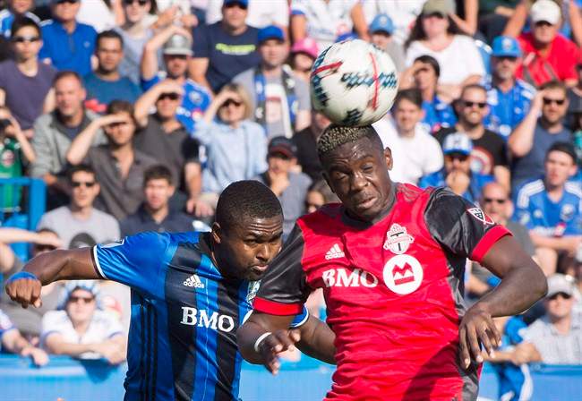 Montreal Impact's Chris Duvall, left, challenges Toronto FC's Chris Mavinga during first half MLS soccer action in Montreal on August 27, 2017. 