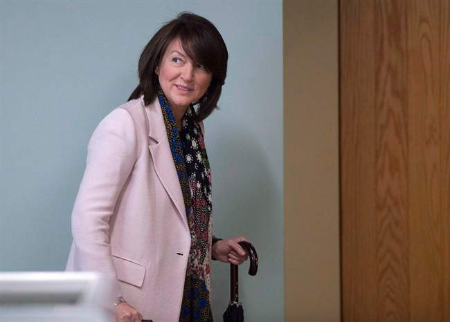 Former Quebec deputy premier Nathalie Normandeau walks to a courtroom.
