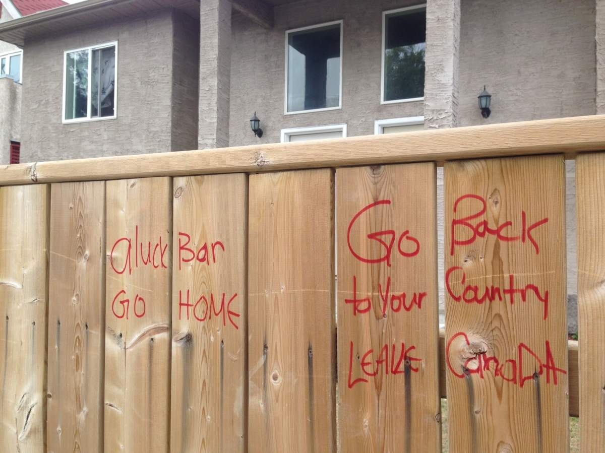 Racist graffiti was found on a Winnipeg fence outside of a Syrian refugee family's home.