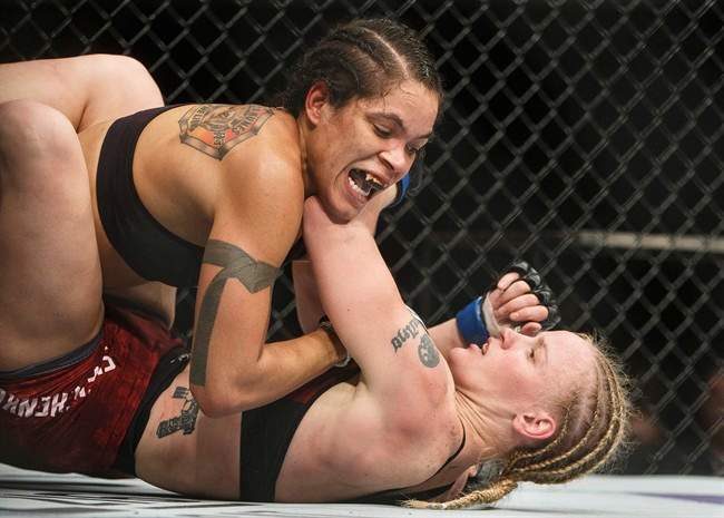 Amanda Nunes of Brazil, top, and Valentina Shevchenko of Kyrgystan battle during their mixed martial arts bout at UFC 215 in Edmonton, Alta., on Saturday September 9, 2017. 