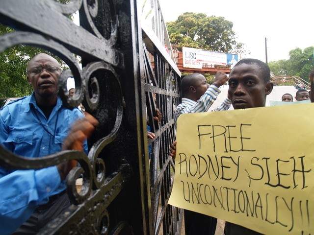 A supporter holds up a sign calling for the release of Rodney Sieh.  