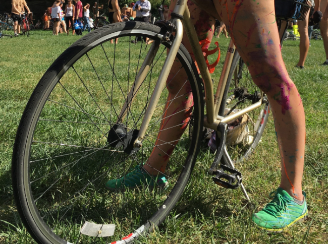 A topless cyclist wearing body paint motions before the start of the annual Philly Naked Bike Ride in Philadelphia, Sept. 9, 2017.