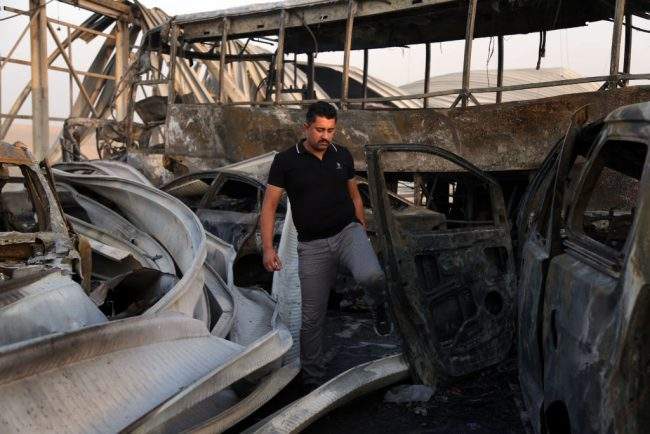 A man looks at the damage after gunmen and suicide car bombers killed dozens of people in two assaults claimed by Islamic State (IS) group jihadists near the southern Iraqi city of Nasiriyah on September 14, 2017.