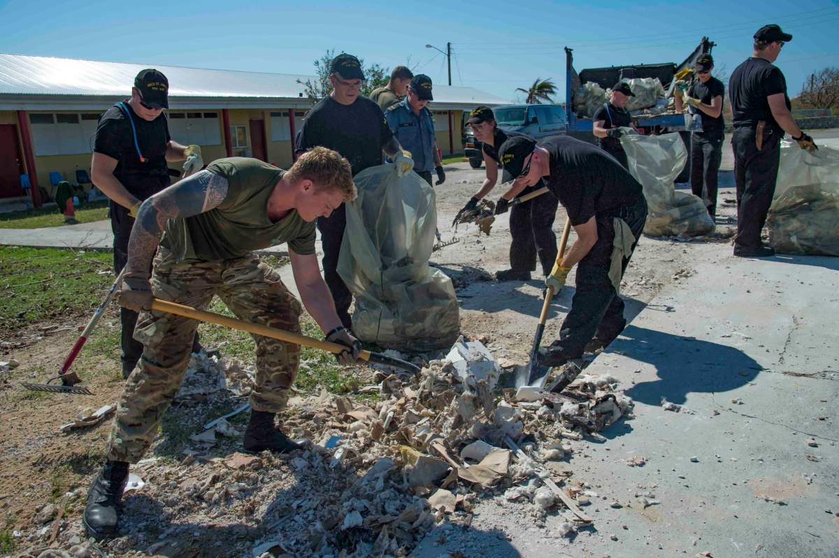 The crew of Her Majesty’s Canadian Ship St. John’s and Royal Marines memebers work together to clean up a school in South Caicos Island