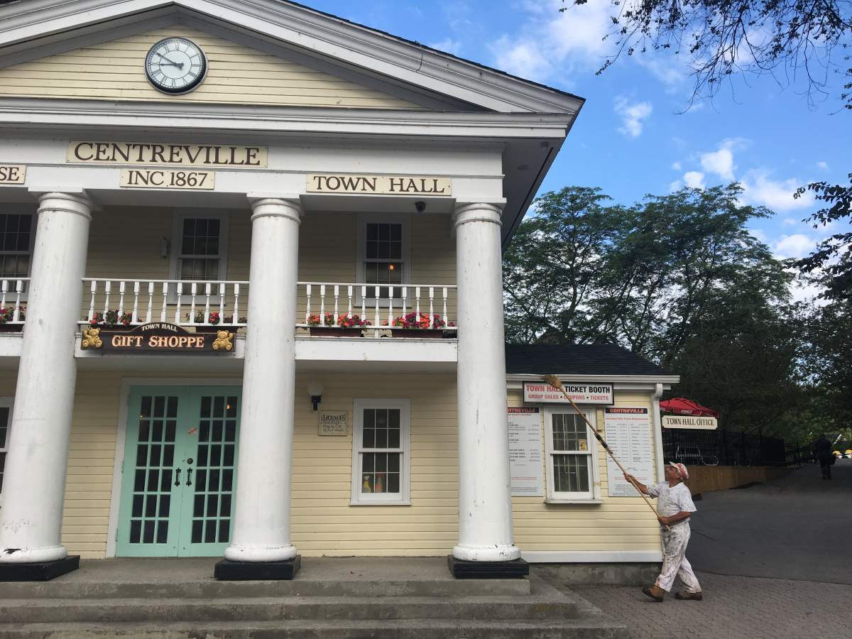 A worker ensures public displays and buildings are spotless in time for visitors to descend on the park on opening day.