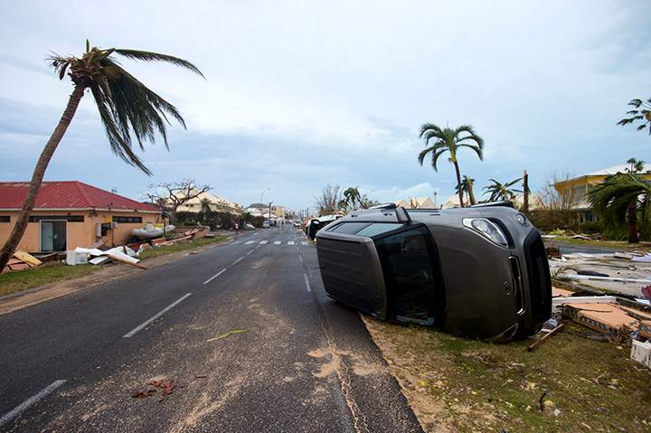 A photo taken on September 6, 2017 shows a car turned onto its side in French side of Saint Martin, after the passage of Hurricane Irma.