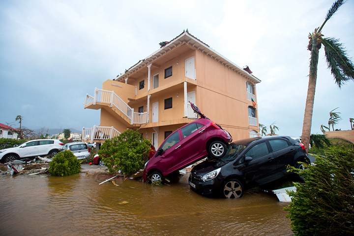 A photo taken on September 6, 2017 shows cars piled on top of one another in French side of Saint Martin, after the passage of Hurricane Irma.