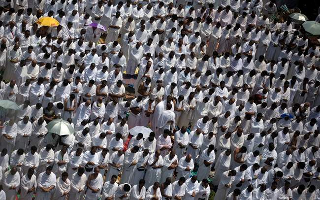 Muslim pilgrims attend noon prayers outside the Namirah mosque on Arafat Mountain, during the annual hajj pilgrimage, outside the holy city of Mecca, Saudi Arabia, Thursday, Aug. 31, 2017.