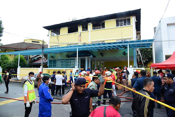 Police and rescue personnel work at an Islamic religious school cordoned off after the fire on the outskirts of Kuala Lumpur, Thursday, Sept. 14, 2017. AP Photo