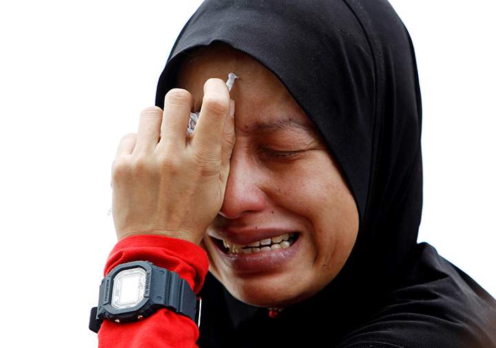 Nadia Azalan, whose brother lost his life in the fire at religious school Darul Quran Ittifaqiyah, cries in Kuala Lumpur, Malaysia September 14, 2017.