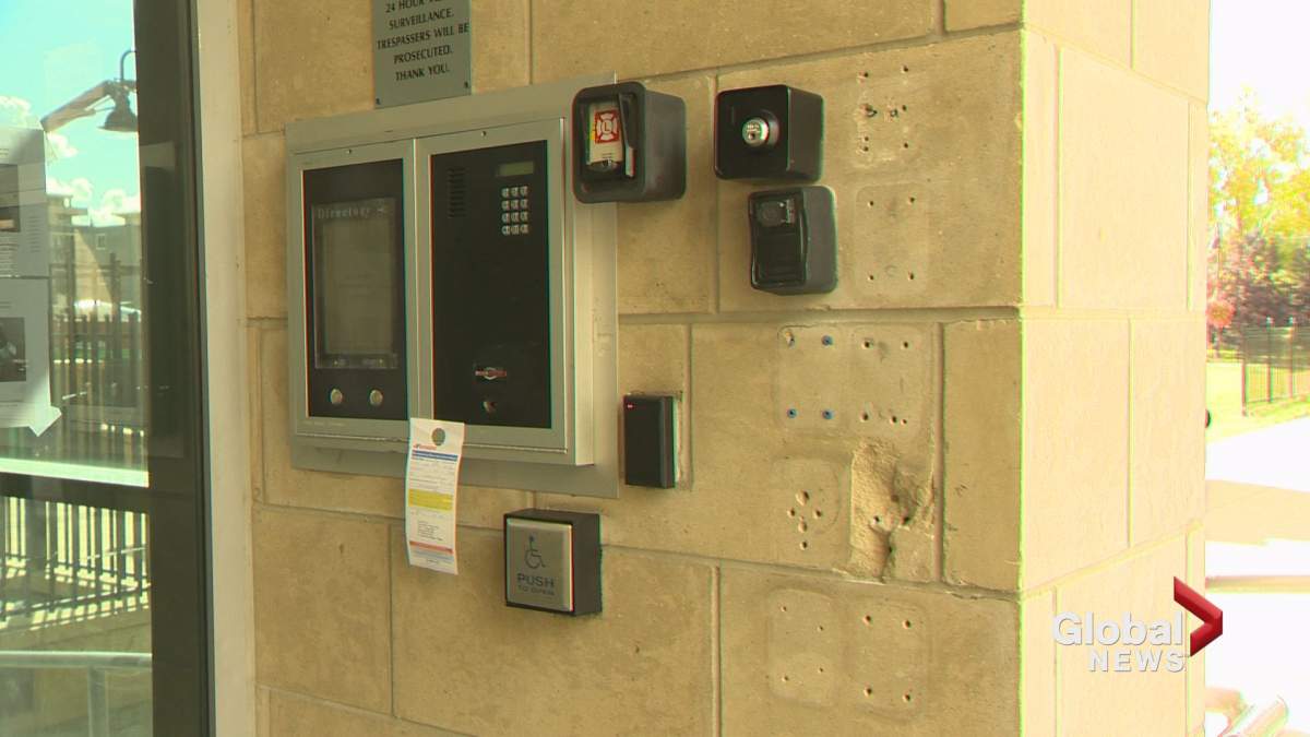 Lock boxes are seen on the outside wall of a condo in Calgary.