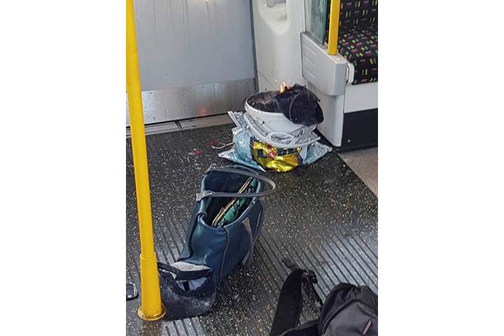 Personal belongings and a bucket with appears to be an item on fire inside it, are seen on the floor of an underground train carriage at Parsons Green station in West London, Britain September 15, 2017, in this image taken from social media.
