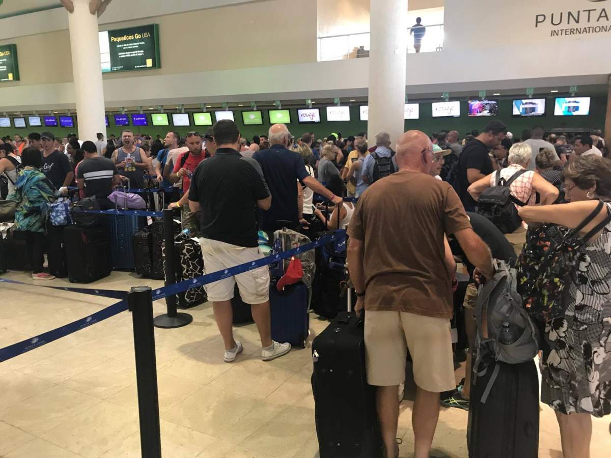 People trying to flee the storm face long lines for evacuation flights in the Punta Cana Internation Airport.