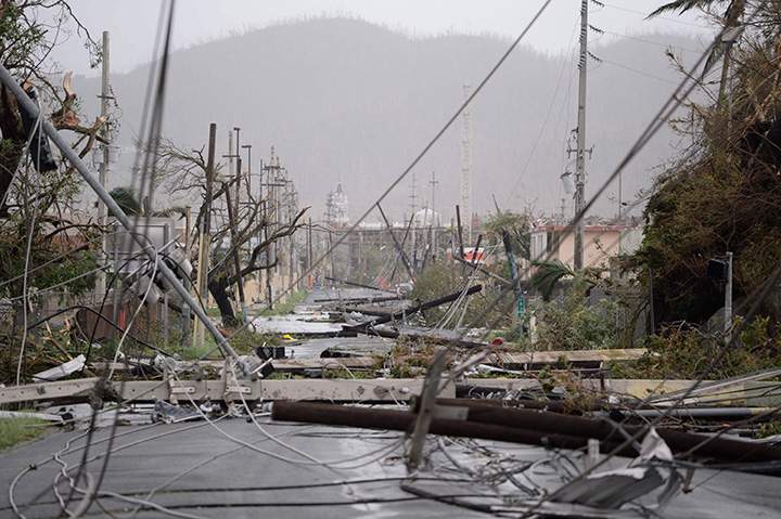 Hydro lines lay toppled on the road after Hurricane Maria hit the eastern region of the island, in Humacao, Puerto Rico.