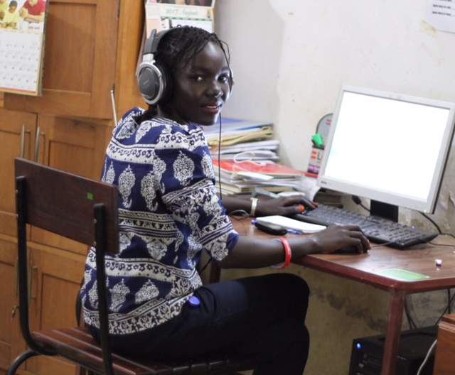 Maura Ajak at a computer. 