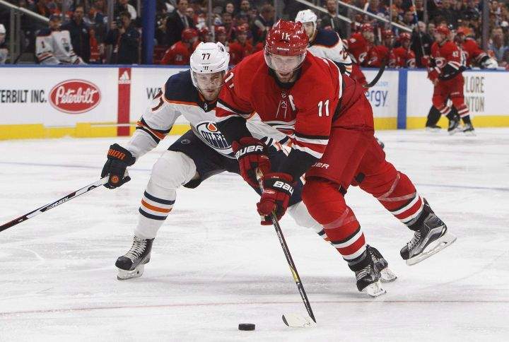 Carolina Hurricanes' Jordan Staal (11) and Edmonton Oilers' Oscar Klefbom, of Sweden, (77) battle for the puck during third period preseason NHL action in Edmonton, Alta., on Monday September 25, 2017. 