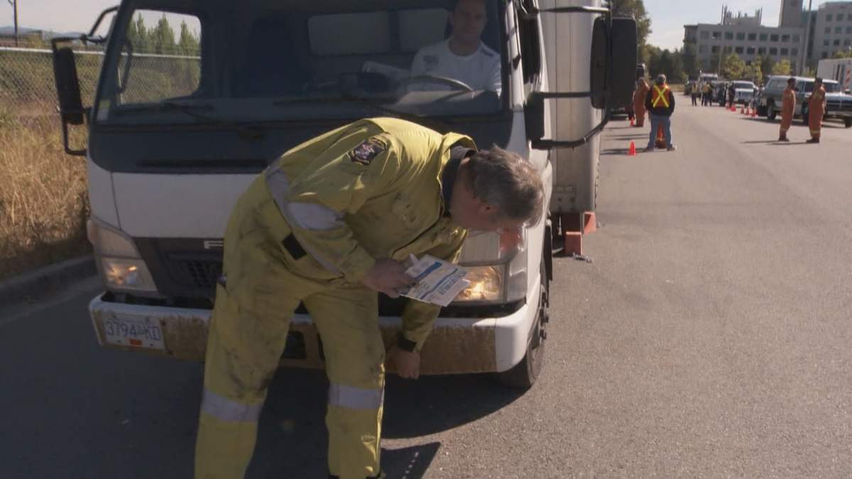 Inspecting a truck in Vancouver for potential safety violations.