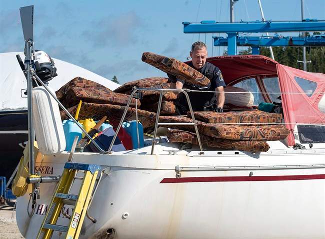 A Canada Border Services Agency officer inspects the sailboat Quesera at East River Marine in Hubbards, N.S., on Friday, Sept. 8, 2017. Approximately 273 kilograms of suspected cocaine were found on the vessel and two men were arrested.