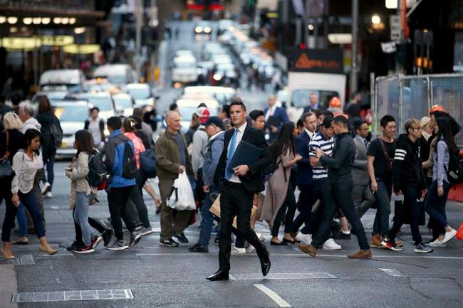 People move about the city as the working day nears its end in Sydney, Wednesday, Sept. 6, 2017. 