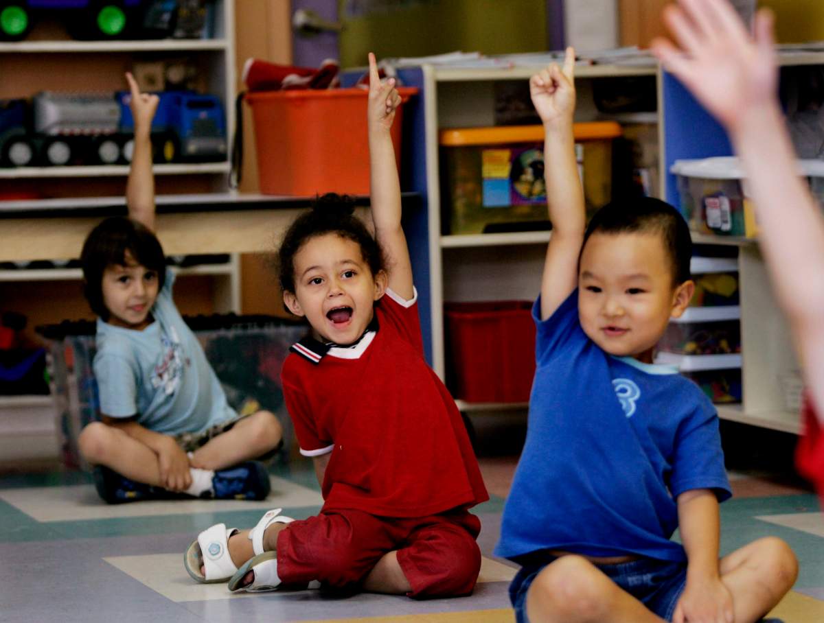 Children put up their hands for ice cream at a daycare centre  in Montreal. 