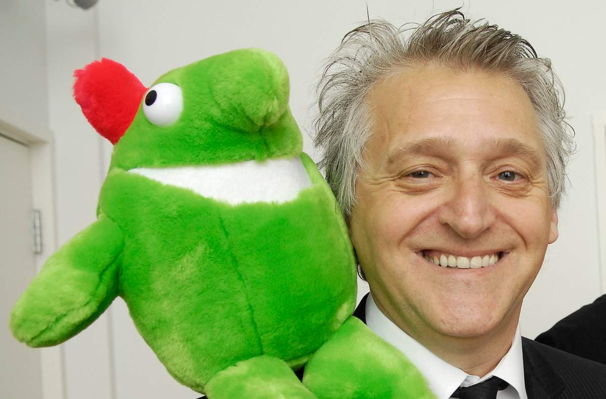 Just for Laughs founder and former CEO Gilbert Rozon poses for a photograph with JFL mascot Victor.