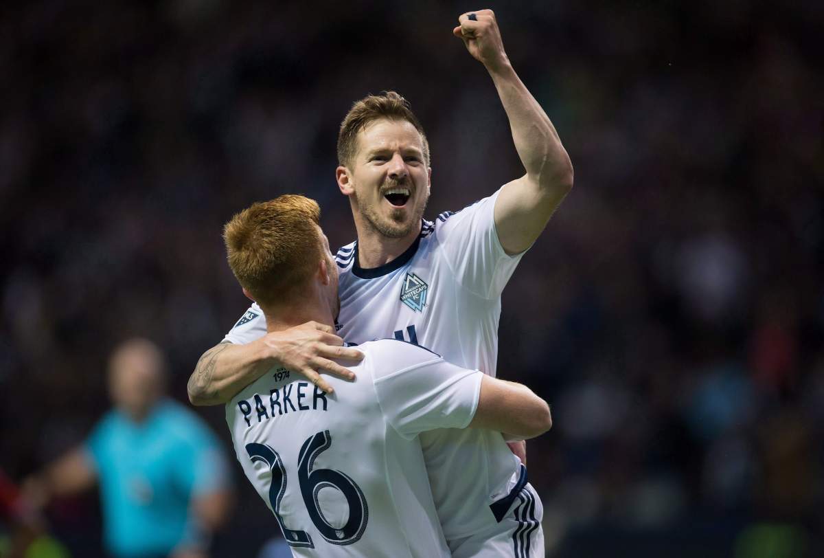 Vancouver Whitecaps' Jordan Harvey, right, and Tim Parker celebrate Harvey's goal against FC Dallas during the second half of an MLS soccer game in Vancouver, B.C., on Saturday April 23, 2016. 
