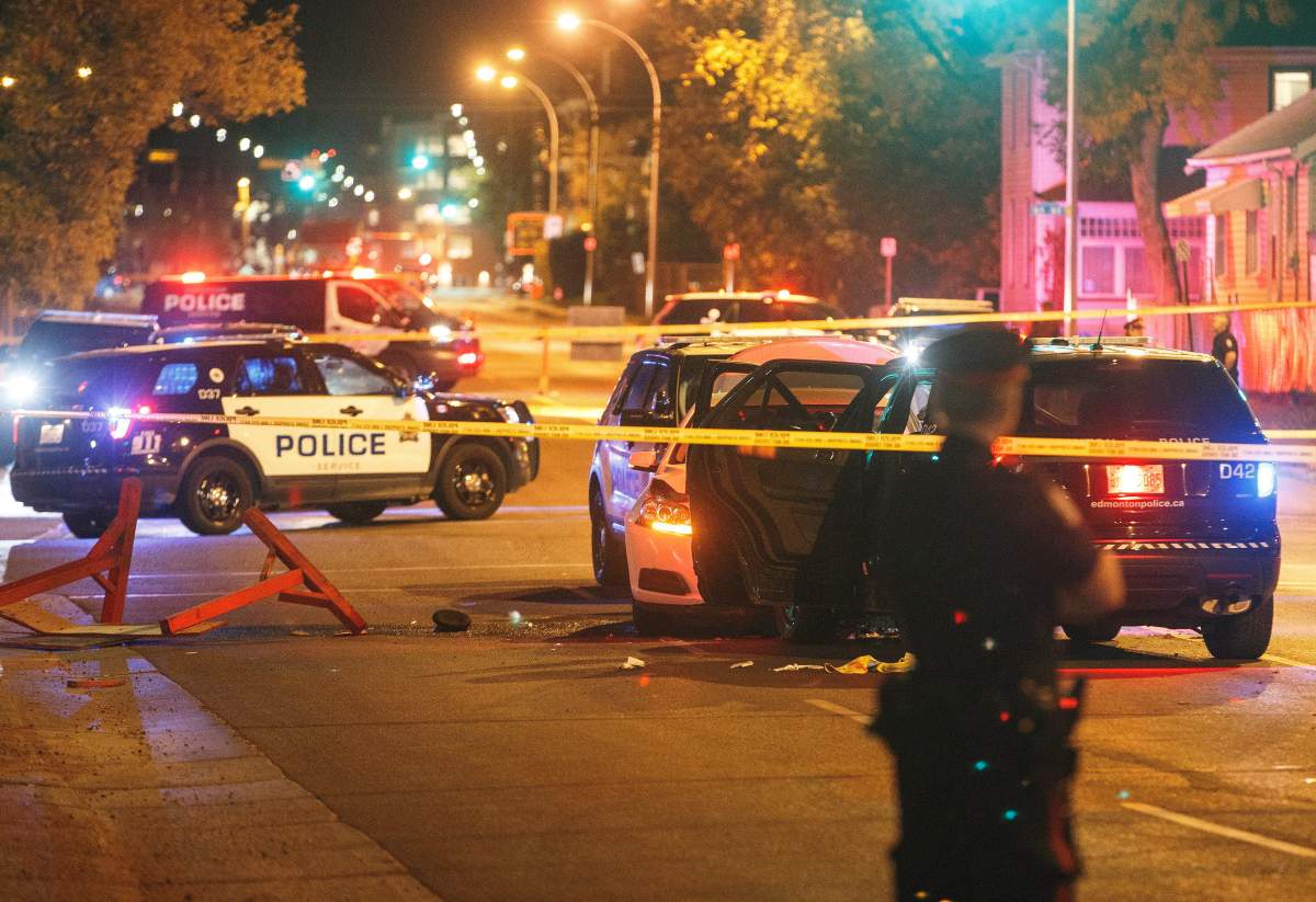 Police investigate the scene where a car crashed into a roadblock in Edmonton Alta, on Saturday September 30, 2017. THE CANADIAN PRESS/Jason Franson