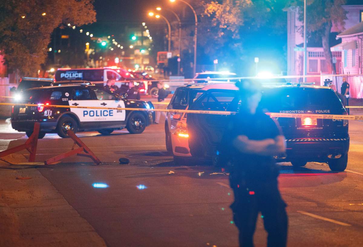 Police investigate the scene where a car crashed into a roadblock in Edmonton Alta, on Saturday September 30, 2017. THE CANADIAN PRESS/Jason Franson