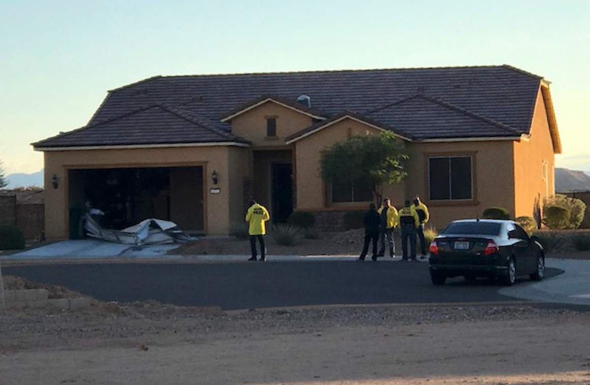 In this photo provided by the Mesquite, Nev., Police Department, police personnel stand outside the home of Stephen Paddock on Monday, Oct. 2, 2017, in Mesquite. Police identified Paddock as the gunman at a music festival Sunday evening.