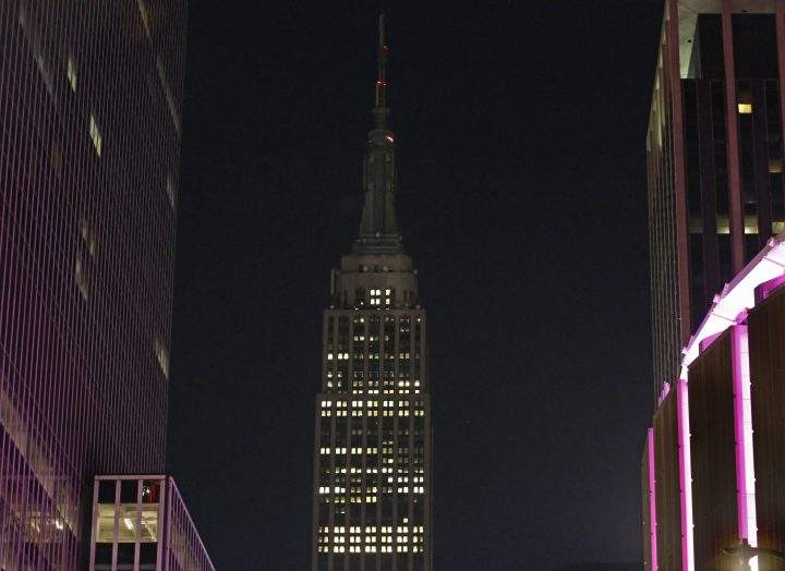 The Empire State Building lights, normally lit in colours, are dimmed Monday, Oct. 2, 2017 in sympathy for the victims of the mass shooting in Las Vegas.
