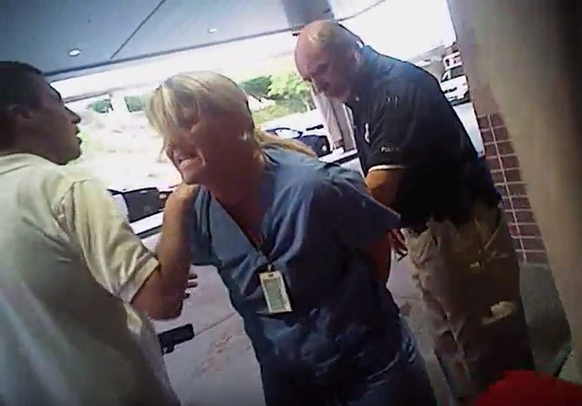 In this July 26, 2017, frame grab from video taken from a police body camera and provided by attorney Karra Porter, nurse Alex Wubbels is arrested by a Salt Lake City police officer at University Hospital in Salt Lake City.