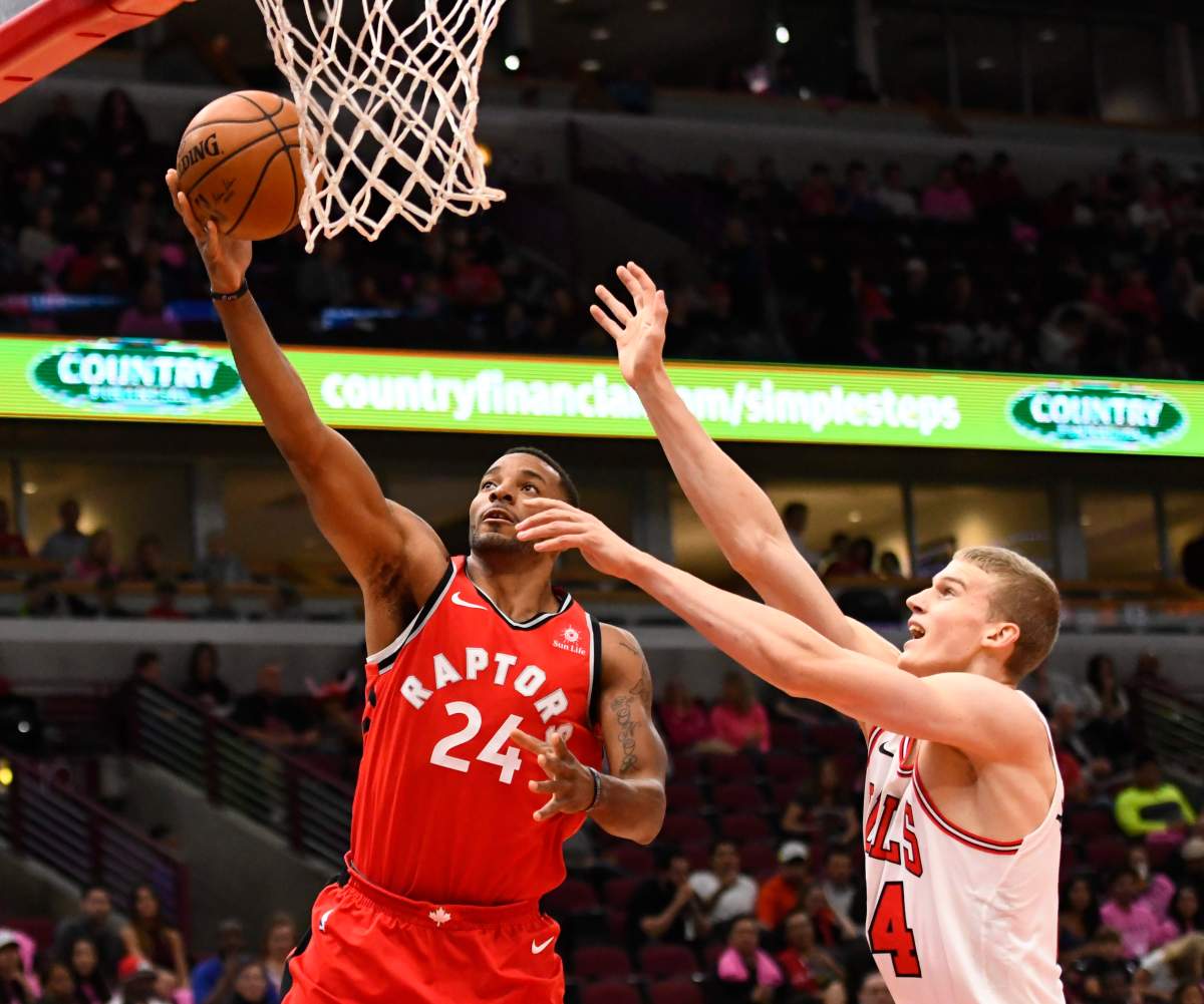 Toronto Raptors guard Norman Powell (24) shoots past Chicago Bulls forward Lauri Markkanen, right, during the first half of an NBA preseason basketball game Friday, Oct. 13, 2017, in Chicago. (AP Photo/Matt Marton).