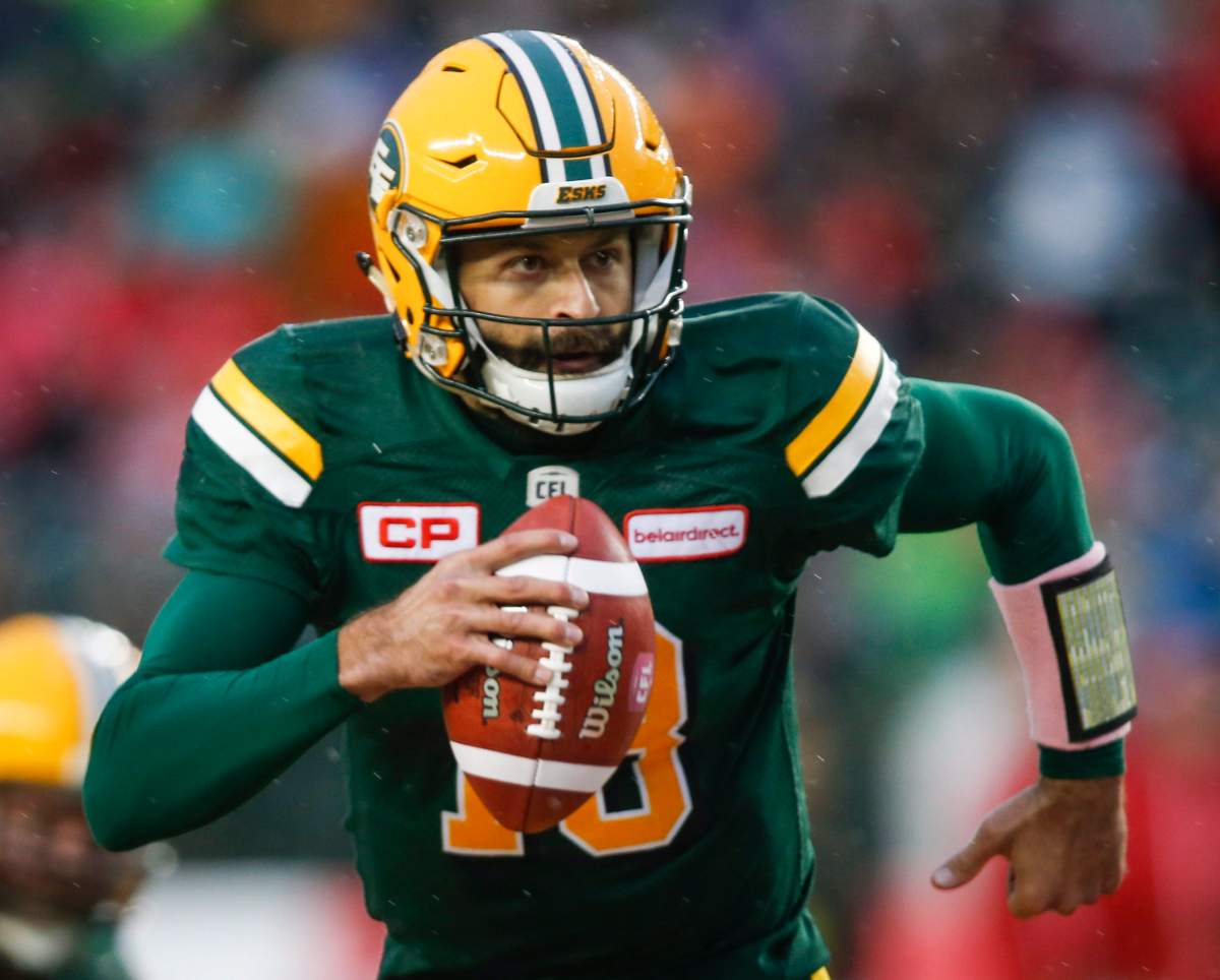 Edmonton Eskimos quarterback Mike Reilly runs with the ball during first half CFL football action against the Toronto Argonauts, in Edmonton, Saturday, Oct. 14, 2017. 