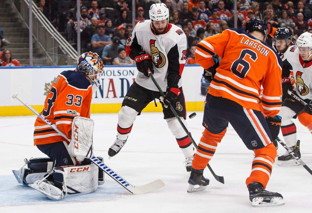 Ottawa Senators’ Zack Smith (15) tries to tip the puck past Edmonton Oilers goalie Cam Talbot (33) as Adam Larsson (6) defends during first period NHL hockey action in Edmonton on Saturday, October 14, 2017. THE CANADIAN PRESS/Jason Franson