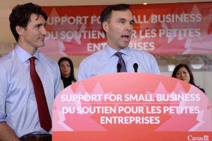 Finance Minister Bill Morneau speaks to members of the media as Prime Minister Justin Trudeau looks on at a press conference on tax reforms in Stouffville, Ont., on Oct. 16, 2017.