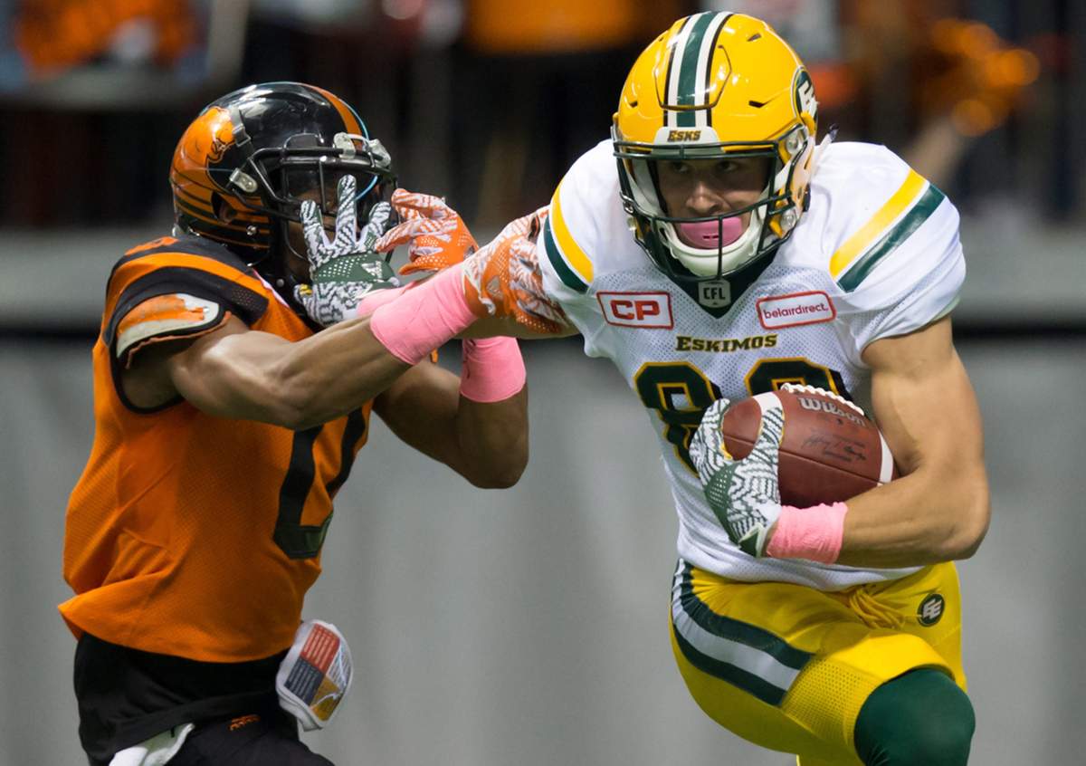 Edmonton Eskimos’ Brandon Zylstra, right, fights off B.C. Lions’ Loucheiz Purifoy during the first half of a CFL football game in Vancouver, B.C., on Saturday October 21, 2017. THE CANADIAN PRESS/Darryl Dyck